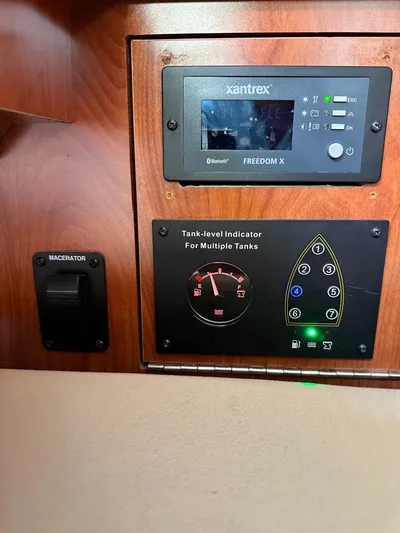 "orion" Yacht Photos Pics Control panel of 2012 Hunter 45 Deck Salon with Xantrex Freedom X and tank indicators.
