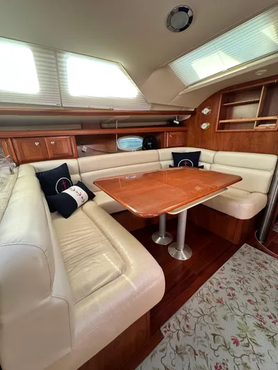 "orion" Yacht Photos Pics 2012 Hunter 45 Deck Salon interior with elegant dining area and plush seating.