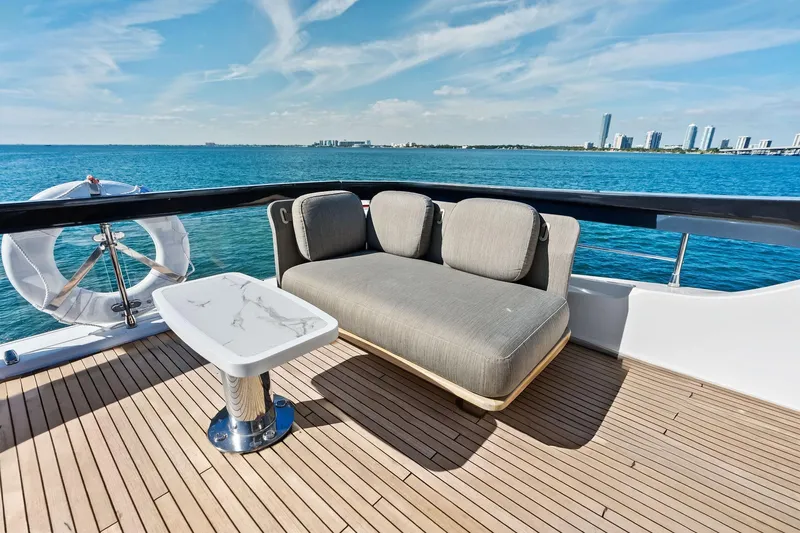  Yacht Photos Pics Luxurious Azimut Fly 78 yacht deck with modern seating, ocean view, and city skyline.
