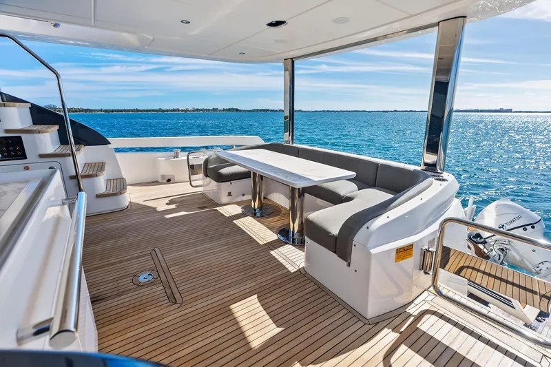  Yacht Photos Pics Luxurious 2021 Azimut Fly 78 yacht deck with elegant seating and ocean view.