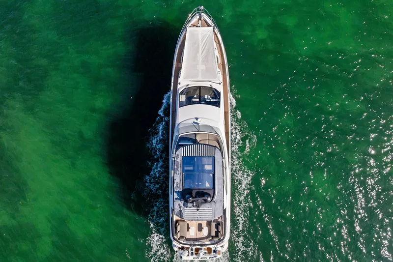  Yacht Photos Pics Aerial view of 2021 Azimut Fly 78 yacht cruising on vibrant green water.