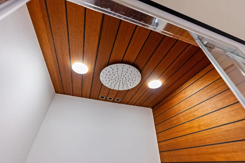  Yacht Photos Pics Wood-paneled shower ceiling with modern lighting in 2021 Azimut Fly 78 yacht.