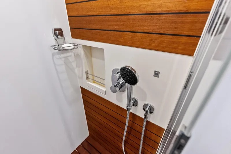  Yacht Photos Pics Luxury shower in 2021 Azimut Fly 78 yacht with wood paneling and modern fixtures.