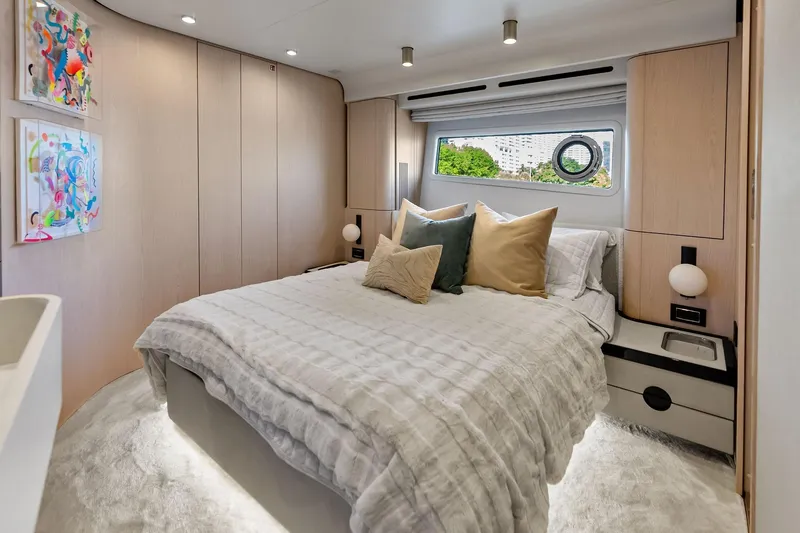  Yacht Photos Pics Luxurious bedroom interior of 2021 Azimut Fly 78 yacht with modern decor and window view.