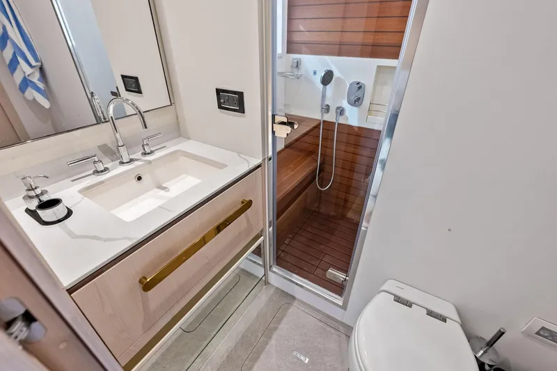  Yacht Photos Pics Luxurious bathroom in 2021 Azimut Fly 78 yacht with modern fixtures and wooden shower.