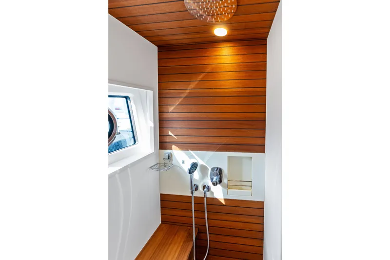  Yacht Photos Pics Luxurious shower area in 2021 Azimut Fly 78 yacht with wood paneling.