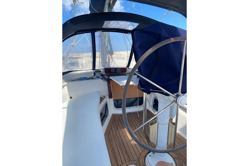  Yacht Photos Pics Hunter 45 Center Cockpit 2000 interior with steering wheel and seating area.