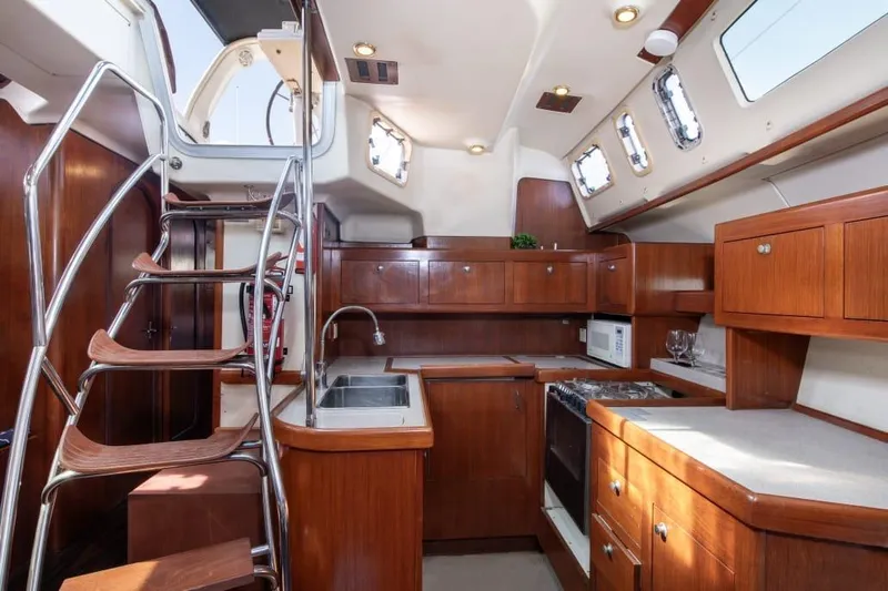  Yacht Photos Pics Interior of 2000 Hunter 45 Center Cockpit yacht with wooden cabinetry and modern kitchen amenities.