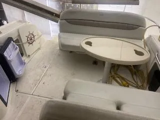 2003 Regal 2765 boat interior with seating, table, and mini fridge.