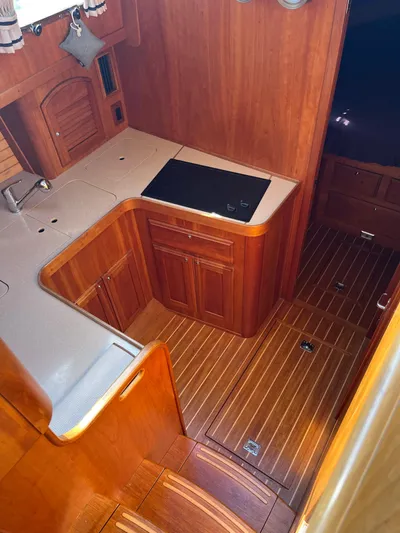 Mon Alisa Yacht Photos Pics 2004 Sabre 36 Sedan yacht interior with wooden cabinetry and flooring.
