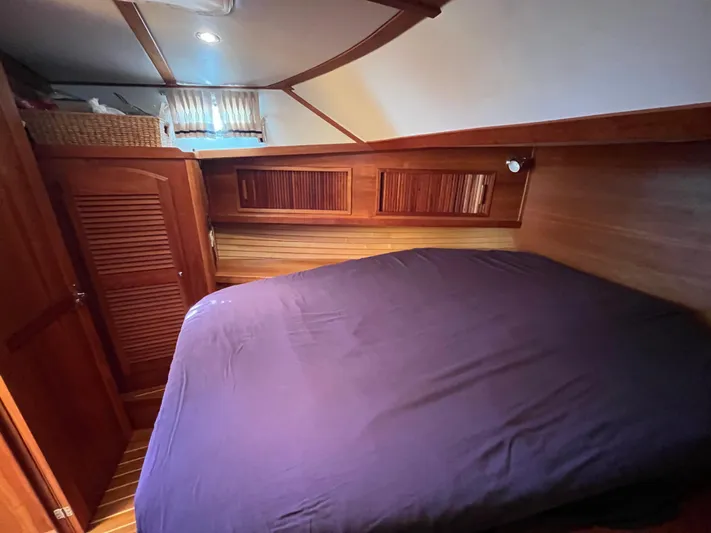 Mon Alisa Yacht Photos Pics Cozy cabin interior of 2004 Sabre 36 Sedan with wooden accents and bed.