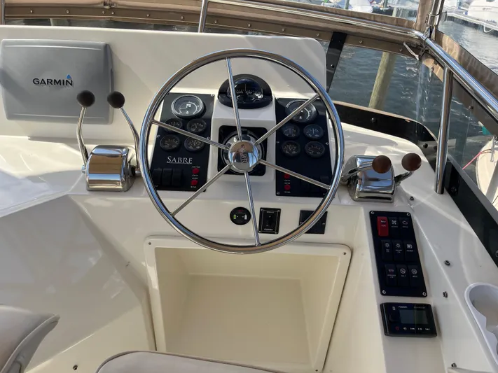 Mon Alisa Yacht Photos Pics 2004 Sabre 36 Sedan helm with Garmin navigation system and classic steering wheel.