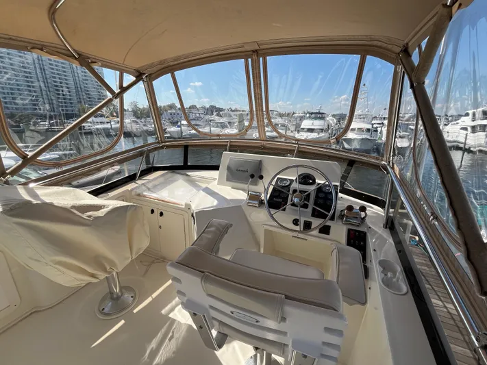 Mon Alisa Yacht Photos Pics 2004 Sabre 36 Sedan helm with marina view, featuring dual seats and navigation controls.