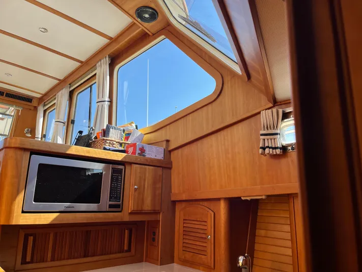 Mon Alisa Yacht Photos Pics Interior of 2004 Sabre 36 Sedan with wood paneling and microwave.