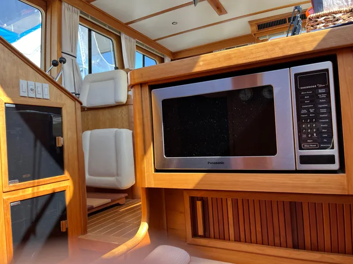 Mon Alisa Yacht Photos Pics Interior of 2004 Sabre 36 Sedan with microwave and seating area.