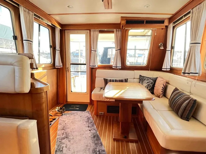 Mon Alisa Yacht Photos Pics Interior of 2004 Sabre 36 Sedan with cozy seating and wooden accents.