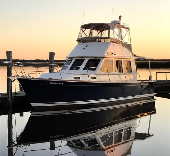 Mon Alisa Yacht Photos Pics 2004 Sabre 36 Sedan yacht docked at sunset, reflecting on calm water.