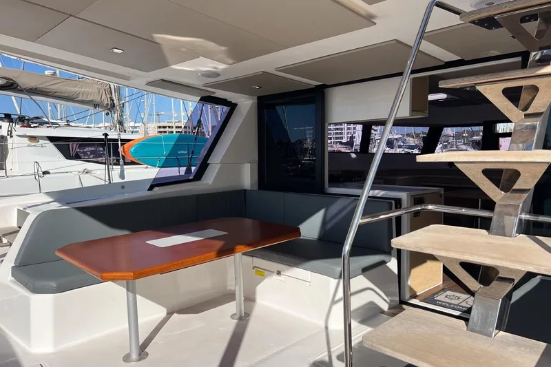 Just Wonder Yacht Photos Pics Modern interior of 2024 Cervetti 44 yacht with seating and wooden staircase.