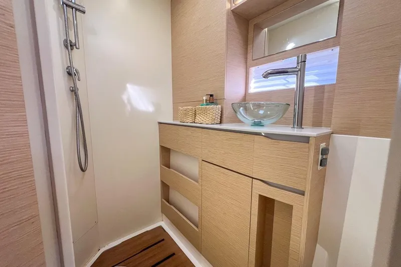 Just Wonder Yacht Photos Pics Modern bathroom in 2024 Cervetti 44 yacht with glass sink and wooden cabinetry.