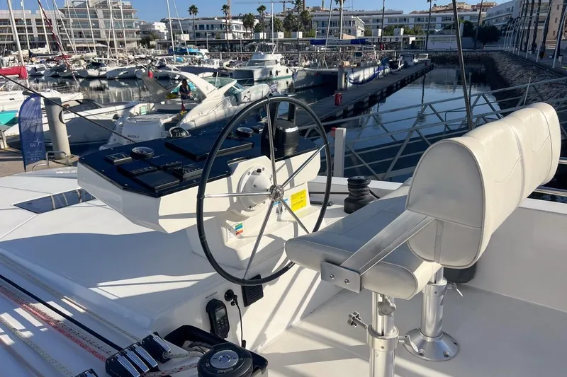 Just Wonder Yacht Photos Pics Helm of 2024 Cervetti 44 yacht in marina, featuring modern controls and seating.