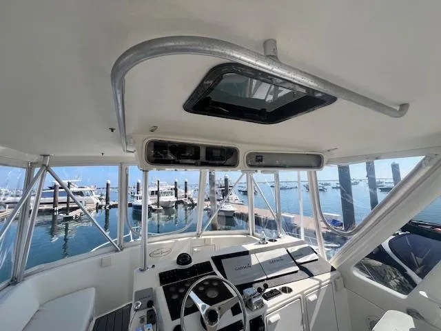 Catherine Ann Yacht Photos Pics 1998 Ocean Yachts 40 Super Sport helm with marina view, featuring modern navigation equipment.