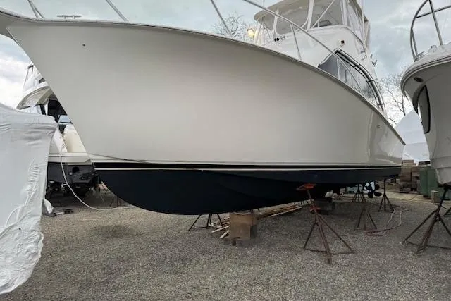 Catherine Ann Yacht Photos Pics 1998 Ocean Yachts 40 Super Sport on stands, side view, in a boatyard.