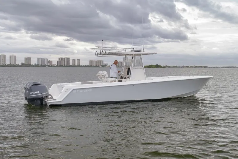  Yacht Photos Pics 2012 Contender 32 Tournament boat on water with Yamaha engine, cloudy sky backdrop.