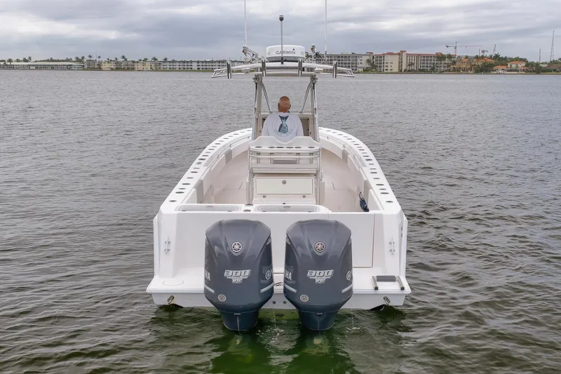  Yacht Photos Pics 2012 Contender 32 Tournament boat with dual Yamaha engines on calm water.