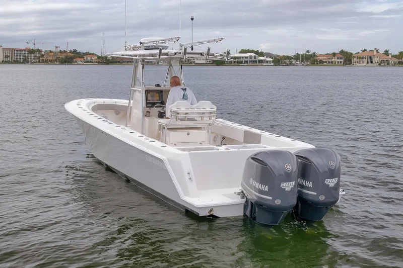  Yacht Photos Pics 2012 Contender 32 Tournament boat with dual Yamaha engines on calm water.