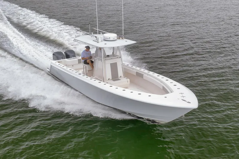  Yacht Photos Pics 2012 Contender 32 Tournament boat cruising on open water, side view.