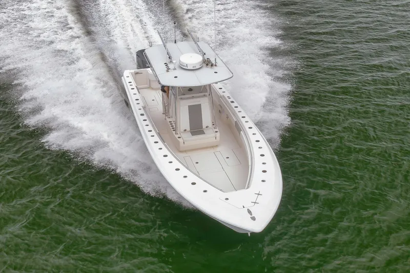  Yacht Photos Pics 2012 Contender 32 Tournament boat speeding on open water.