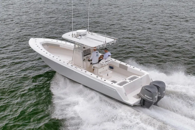  Yacht Photos Pics 2012 Contender 32 Tournament boat cruising on open water with twin Yamaha engines.