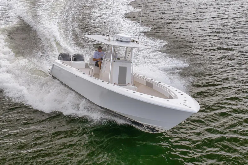  Yacht Photos Pics 2012 Contender 32 Tournament boat cruising on water, showcasing sleek design and powerful performance.