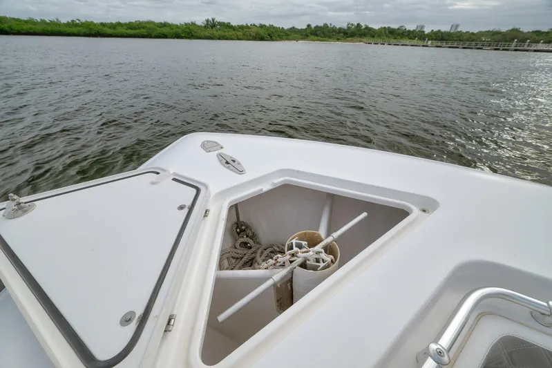  Yacht Photos Pics 2012 Contender 32 Tournament boat with open anchor storage, near calm waters.