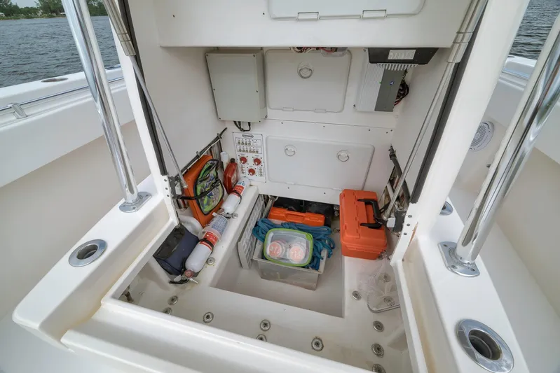  Yacht Photos Pics 2012 Contender 32 Tournament boat storage area with safety equipment and tools.