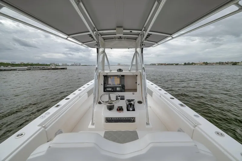  Yacht Photos Pics 2012 Contender 32 Tournament boat interior with steering console on open water.