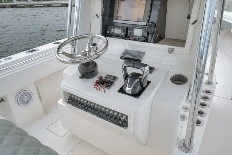  Yacht Photos Pics 2012 Contender 32 Tournament boat helm with steering wheel and navigation equipment.