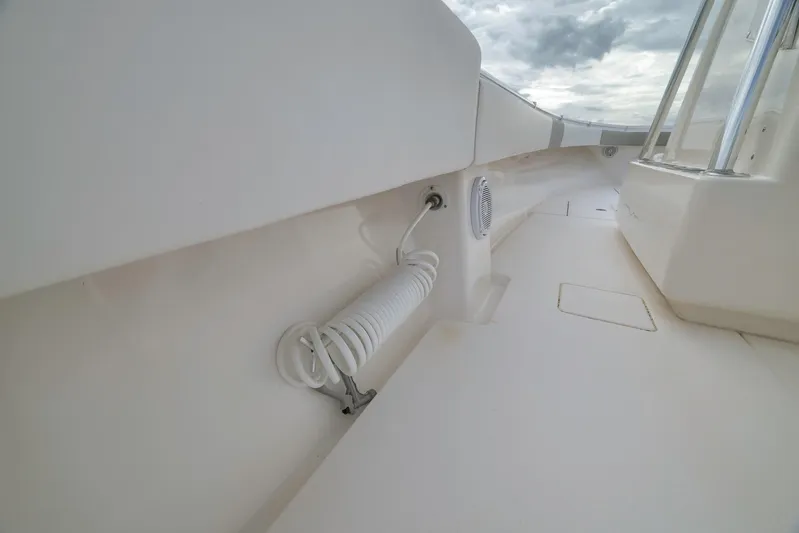  Yacht Photos Pics 2012 Contender 32 Tournament boat deck with coiled hose and speaker.