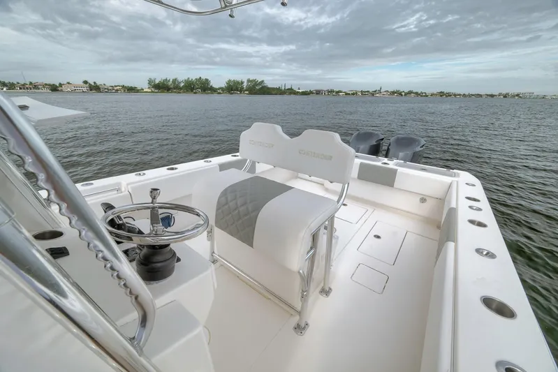  Yacht Photos Pics 2012 Contender 32 Tournament boat with dual engines on calm water.