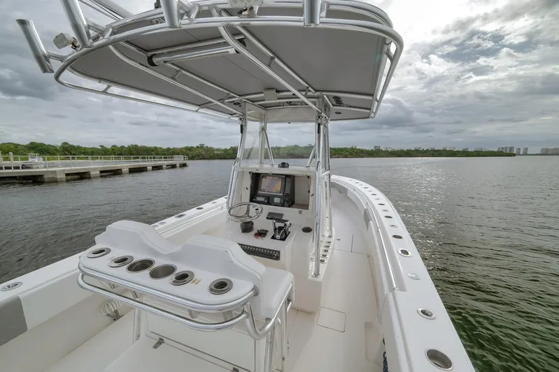  Yacht Photos Pics 2012 Contender 32 Tournament boat on calm water, featuring a sleek console and seating.