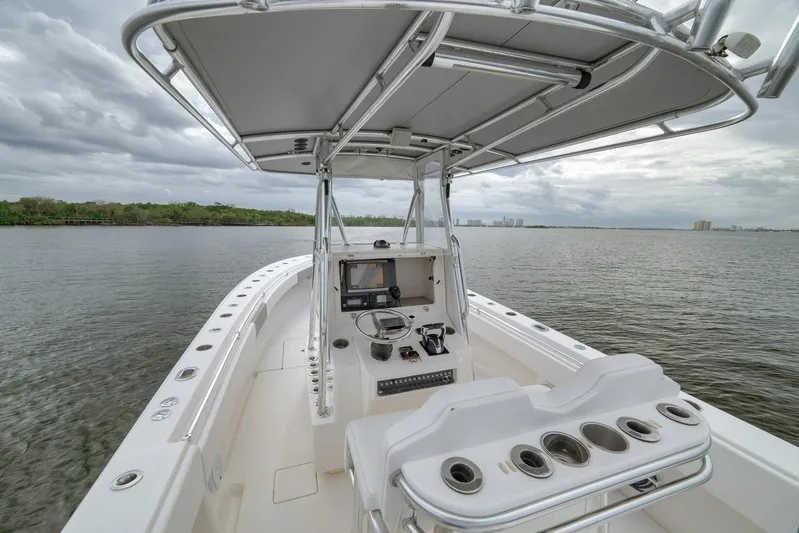  Yacht Photos Pics 2012 Contender 32 Tournament boat on calm water, featuring a sleek console and rod holders.