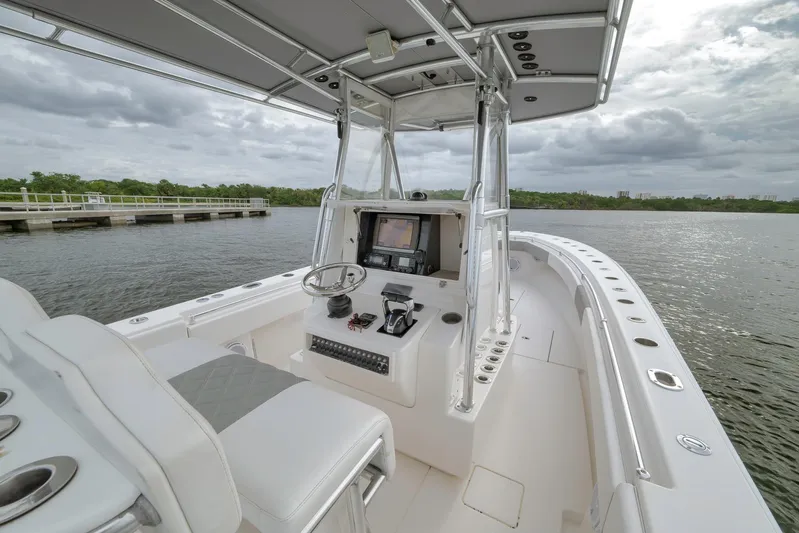  Yacht Photos Pics 2012 Contender 32 Tournament boat interior with helm, steering wheel, and navigation system.
