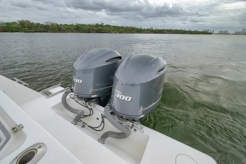  Yacht Photos Pics 2012 Contender 32 Tournament boat with twin 300 horsepower engines on a calm waterway.