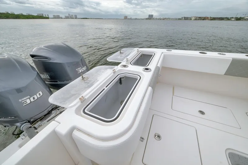  Yacht Photos Pics 2012 Contender 32 Tournament boat with Yamaha 300 engines on a calm water backdrop.