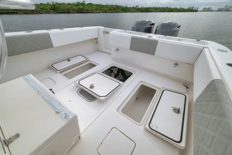  Yacht Photos Pics 2012 Contender 32 Tournament boat deck with storage compartments and dual engines.