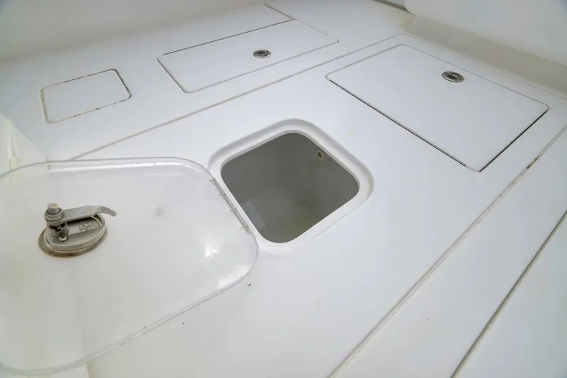  Yacht Photos Pics 2012 Contender 32 Tournament boat storage compartments with open hatch.
