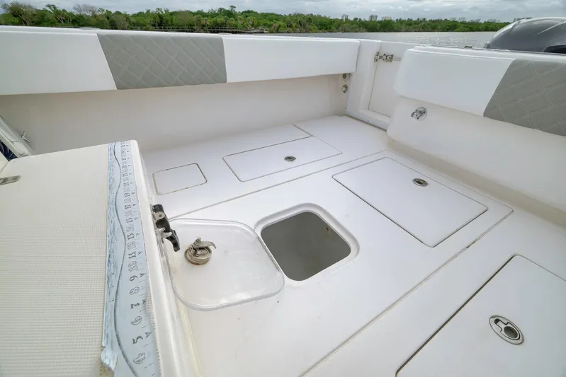  Yacht Photos Pics 2012 Contender 32 Tournament boat deck with storage compartments and seating.