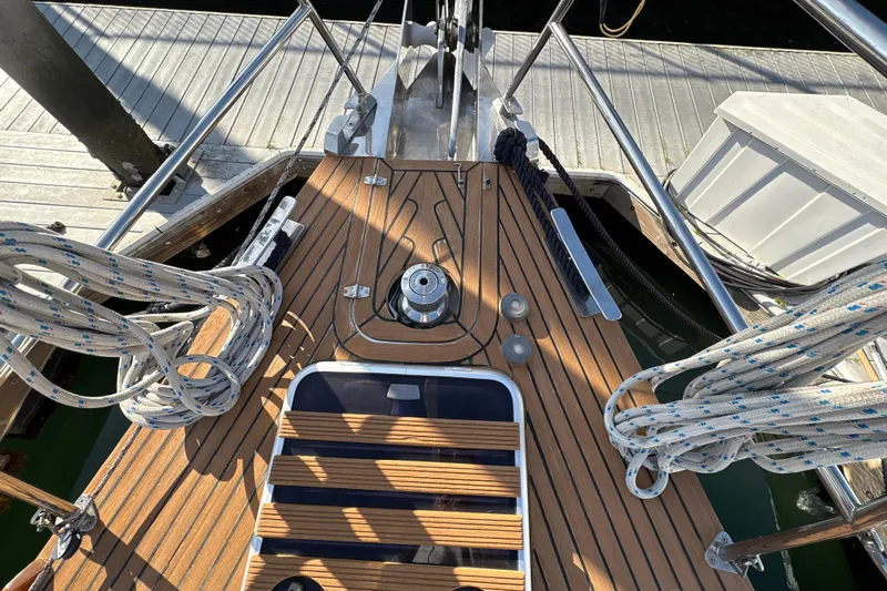 Ganymede Yacht Photos Pics Deck of 2001 North Wind 56 yacht with ropes and winch, docked at marina.