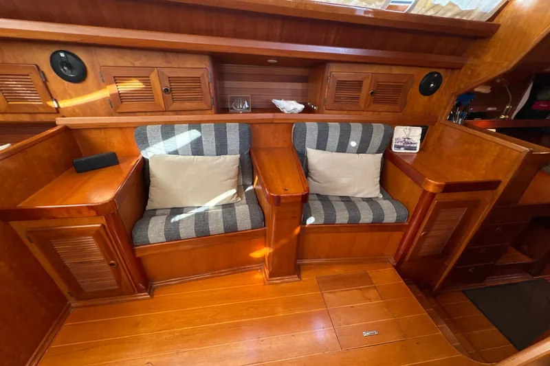Ganymede Yacht Photos Pics Luxurious wooden interior of 2001 North Wind 56 yacht with striped seating.