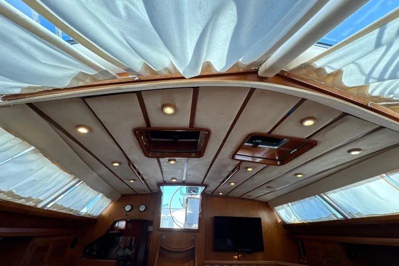 Ganymede Yacht Photos Pics Interior view of 2001 North Wind 56 yacht with elegant wood paneling and ceiling lights.